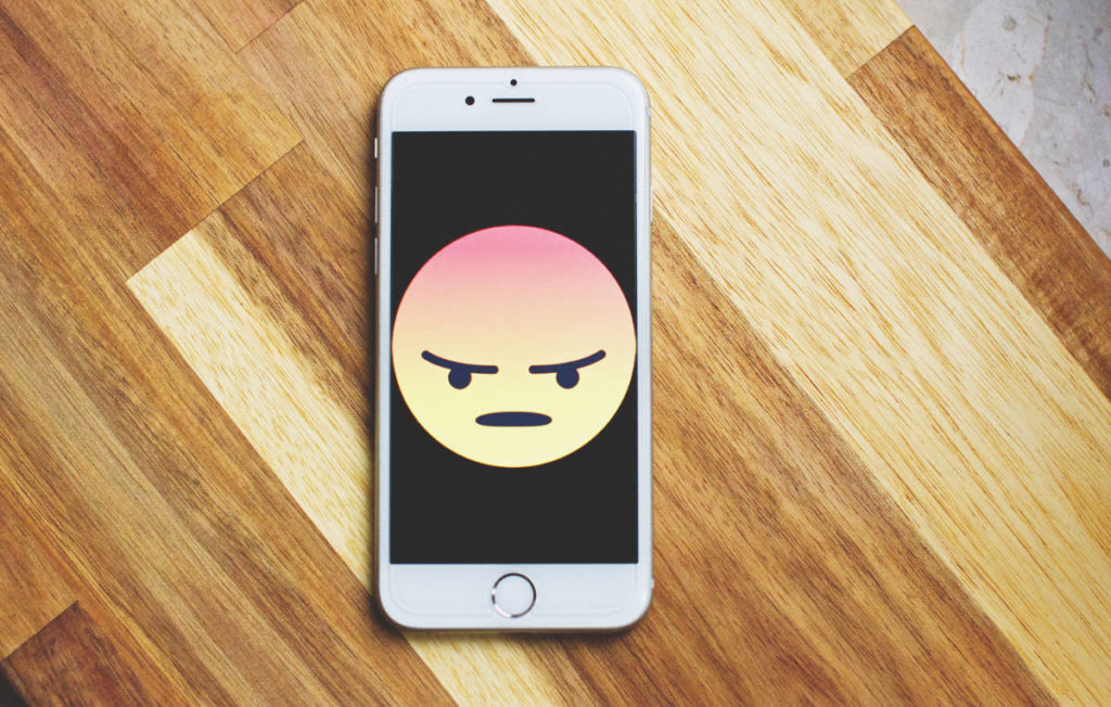 phone that has a angry emoji