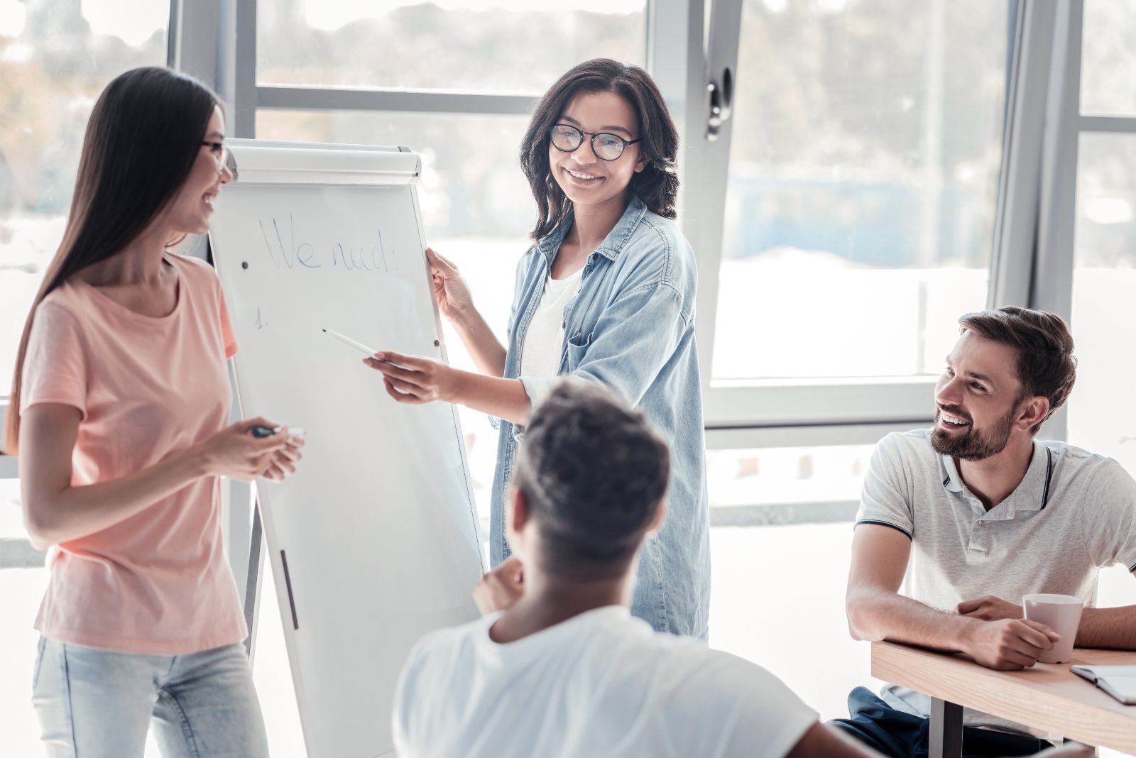 woman presenting during a meeting on a poster board