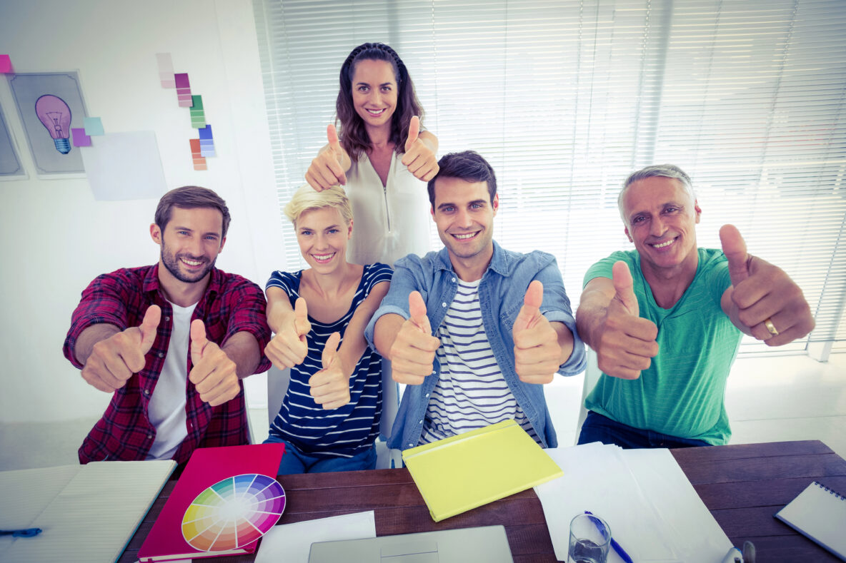 A team of people giving the thumbs-up gesture.