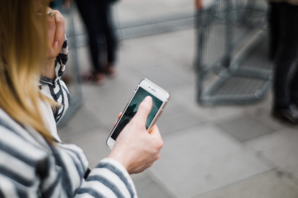 woman holding cell phone