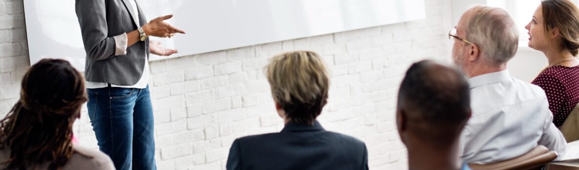 People sitting and listening to a speaker or trainer.