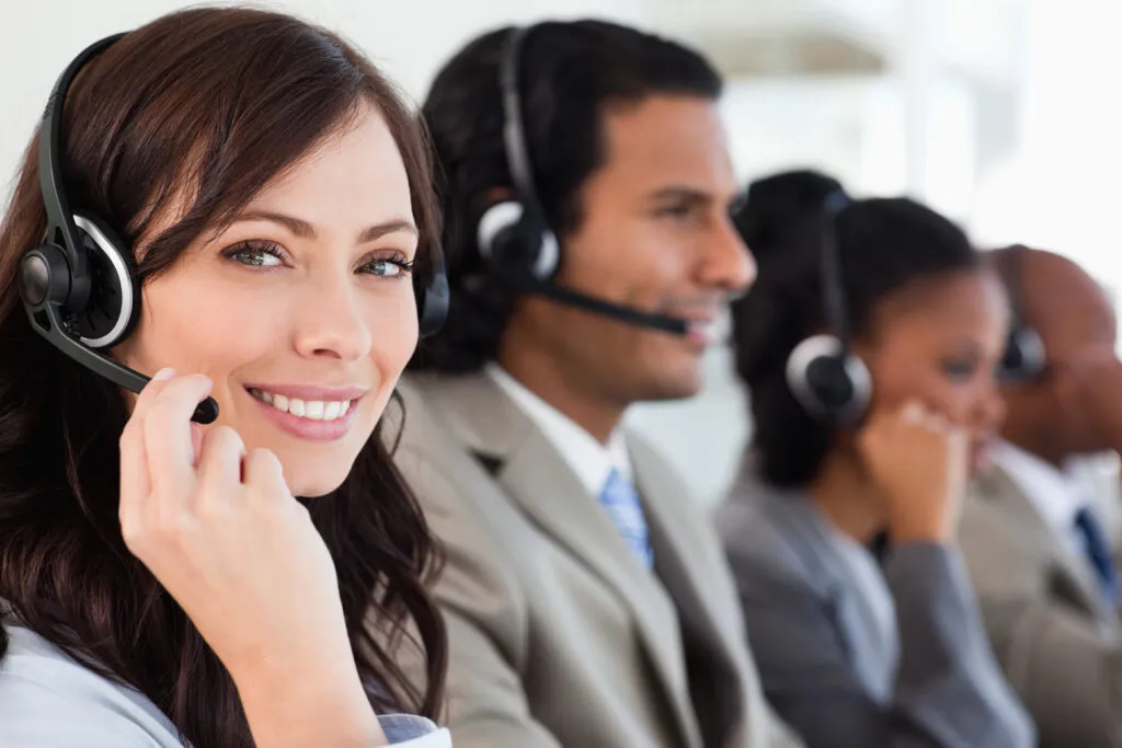 Customer service team wearing headsets in a call center environment