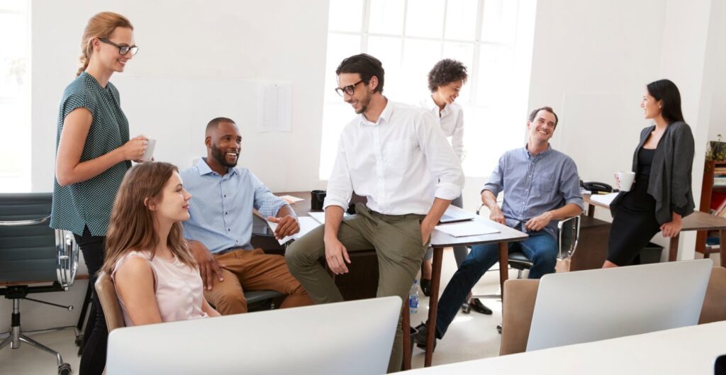 group of people hanging out and talking in an office