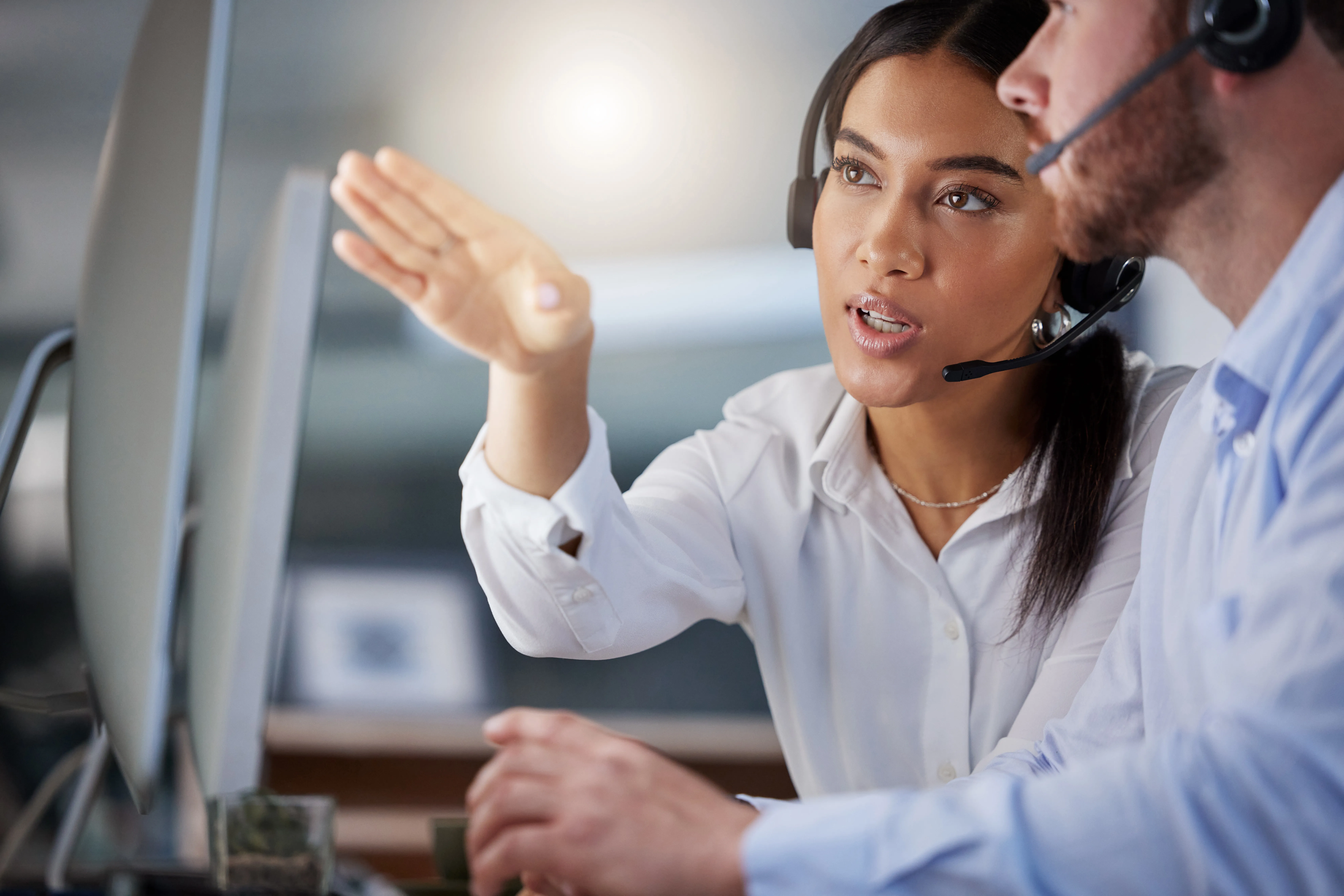 Customer service coach guiding team member during call center training