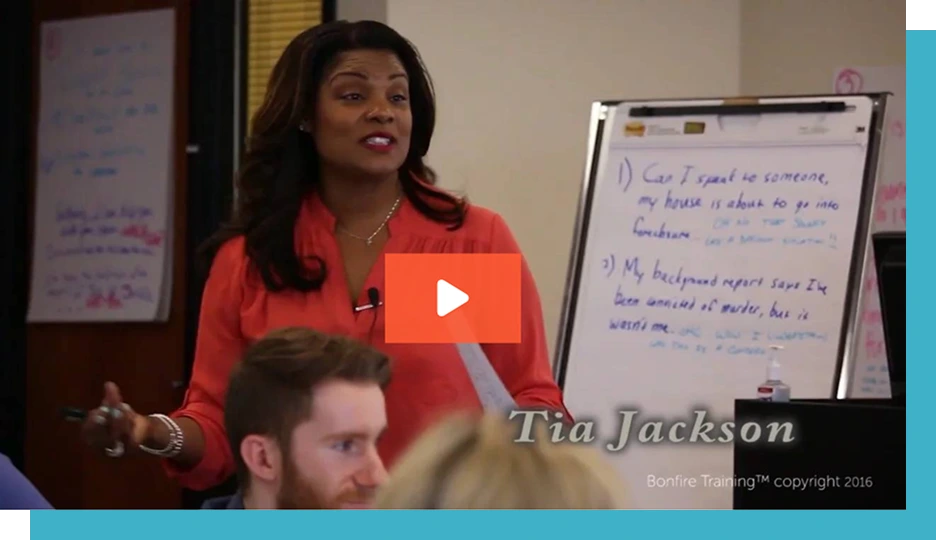 A woman is speaking confidently in a classroom, holding papers near a whiteboard with notes. Text: "1) Can I speak to someone, my house is about to go into foreclosure." "3) My background report says I've been convicted of murder, but it wasn't me." "Tia Jackson, Bonfire Training™ copyright 2016."